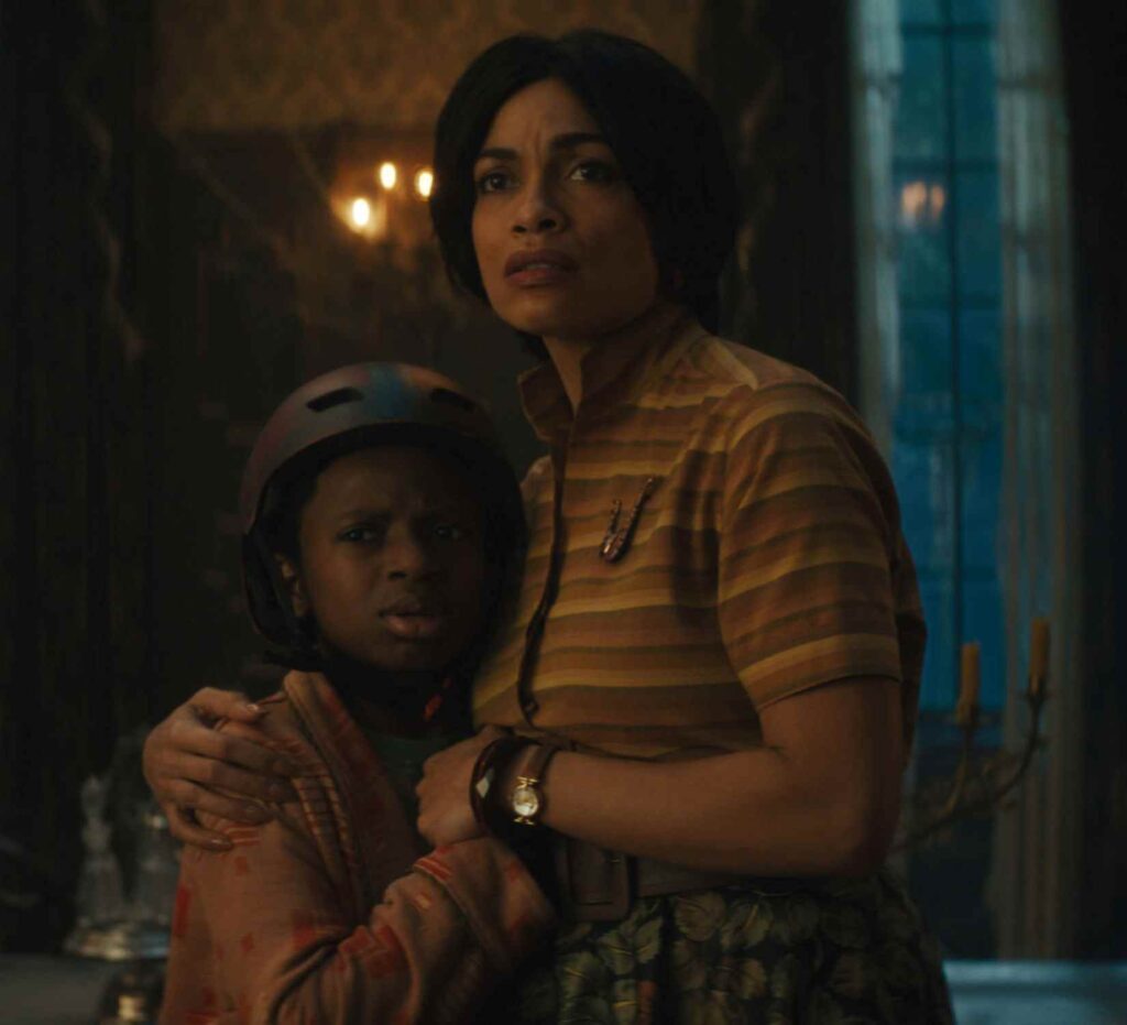 Chase Dillon as Travis and Rosario Dawson as Gabbie in Disney's live-action 'Haunted Mansion'.